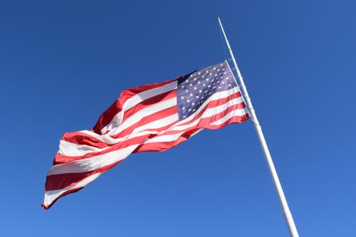 Large American Flag Flying in the Blue Sky